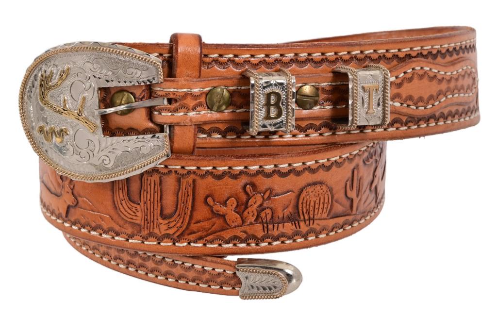 King Ranch Custom Buckle and Tooled Leather Belt: Relief engraved with King Ranch "Running W" brand. Gold and sterling inlayed buckle, stays, and end tip. Approx. 44" L.