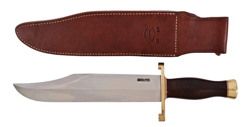 Randall Made Smithsonian Bowie Knife & Sheath: Model 12-11, circa 1980's. Features 10.75" blade, overall length 16.5". Model A sheath w/orange stone. Burlwood handle, brass guard and hilt. Excellent condition