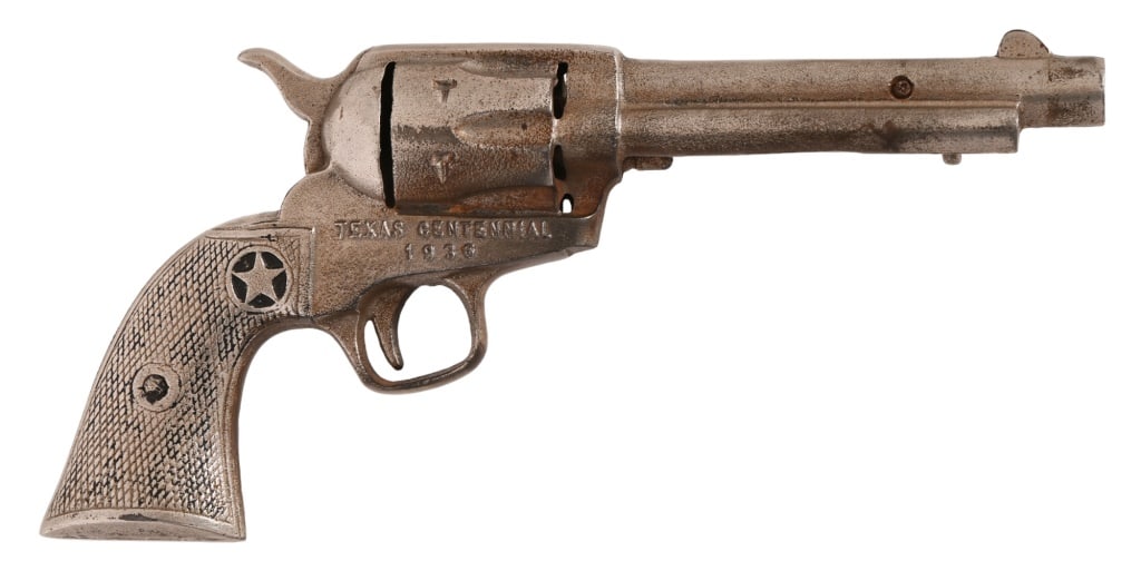 Texas Centennial Judge Roy Bean Souvenir Pistol: Texas Centennial 1936 souvenir from the Judge Roy Bean exhibit. Non-firing Colt SAA cast replica with no moving parts. A rare Texas Centennial find, measures 5.5" x 11".
