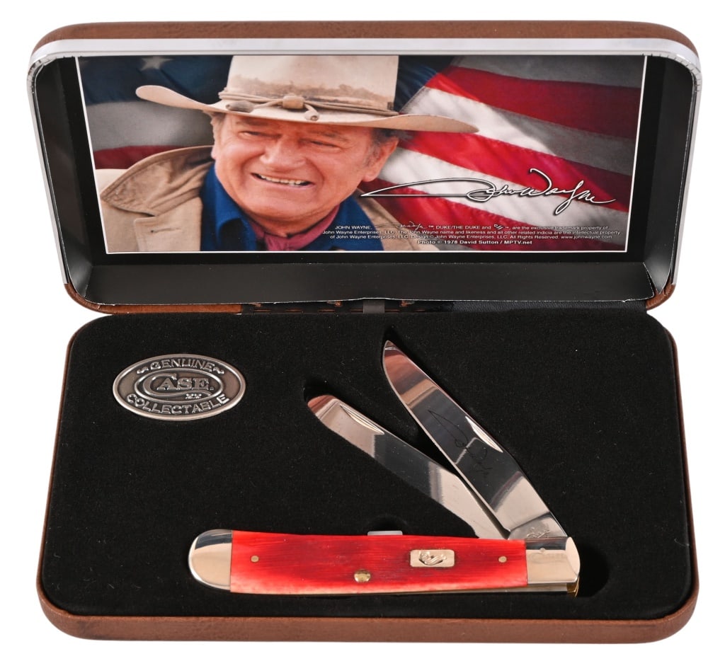 Case XX John Wayne Commemorative Trapper Knife: Case XX trapper folding knife with The Duke's signature on one of the blades. Barnboard jigged dark red-bone handle. Tr-Sharp stainless steel clip & spey blades. Incollector case, with Case XX medalli