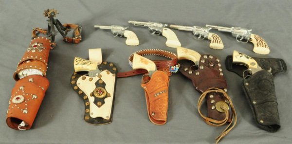 Vintage Cap Gun & Holster Collection: Hubley, Texas Jr., and Pony Boy cap guns. 2 leather cowboy cuffs. 1 holster with gun belt, 3 holsters. 4 unmarked cap guns, pair of childs spurs.