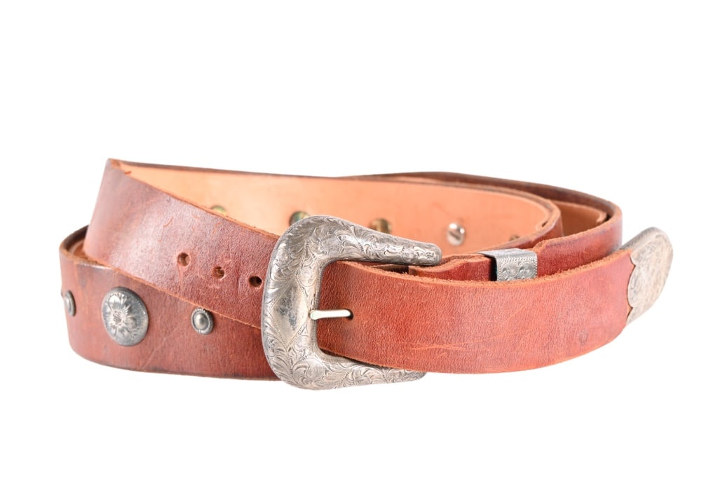Edward H. Bohlin Western Silver Concho Belt: Made by Edward H. Bohlin, Hollywood, California. Features western scroll engraved and Bohlin marked buckle, stays and end. Belt measures 60.5" in overall length, with fitting holes ranging 49.5"-52.5"