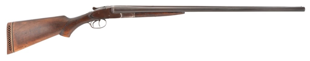 L.C. Smith Double Barrel Shotgun 12 Ga: S/N 805734. Double 30" barrels, field grade. Gray patina finish on metal, wood is solid with handling marks, scuffs. Action functions, 39 stamped on left side of receiver.