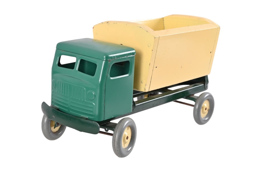 Vintage Pressed Steel Pull Toy Dump Truck: Truck is steel with wood dump bed. Dumps from side to side.6 1/2" W x 8 1/2" T x 16 1/2" L.