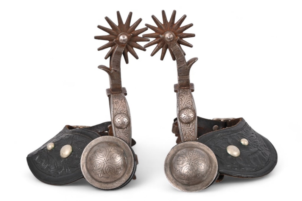 Mike Morales Single Mounted Engraved Spurs: No markings but appears as Mike Morales' engraving. Large 2.25" visalia concho buttons adorn period floral carved leather straps. Features heel-chains, along with chap guard on shank.