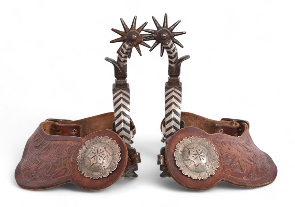 AB Buermann Marked Chevron Pattern Spurs: Chevron silver inlay pattern, features large concho buttons and heel chains. Tooled leather straps by Jerry Dyck, Prineville Oregon.