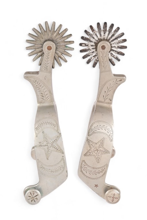 Buermann Star Steel Marked Spurs: Engraved with two half moons surrounding a lone star. Features 2" rowels, with chap guard on shank.