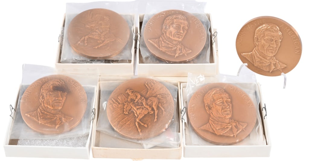 (6) John Wayne 1979 US Mint Bronze Medallions: U.S. Mint Three-inch bronze commemorative medallions. Four are still in original boxes. L.A. Times posted in Wayne's obituary: "In the days that followed his final cancer surgery, Congress, in a histo