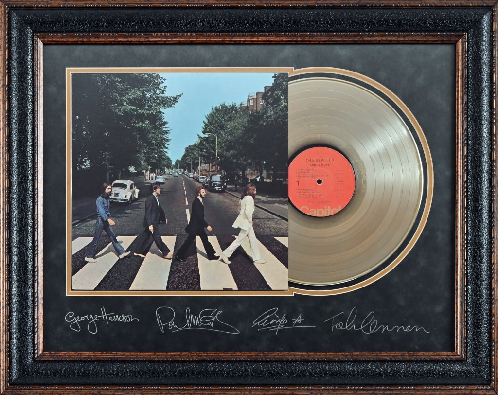The Beatles Signed "Abbey Road" Gold LP Display: Framed "Abbey Road" gold vinyl LP presentation (23x29), with matting signed by George Harrison, Paul McCartney, Ringo Starr, and John Lennon.