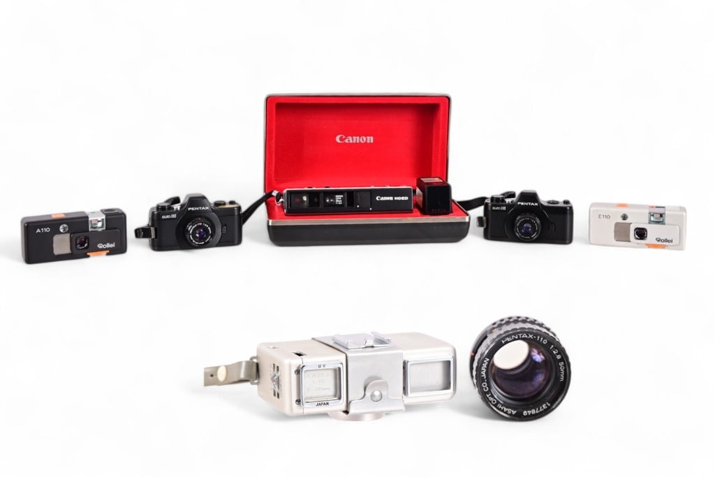 Collection of (5) Vintage 110 Format Cameras: Canon 110ED NOS in original box, (2) Pentax Auto 110, (2) Rollei E110 and A110 models.
