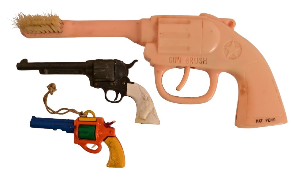 Three Miniature Toy Cowboy Pistols: Three (3) Miniature Toy Cowboy Pistols. (1) Miniature Gun Toothbrush, 6". (1) Miniature Cap Pistol 3 1/4". (1) Miniature Pistol Puzzle Game. Excellent Condition.