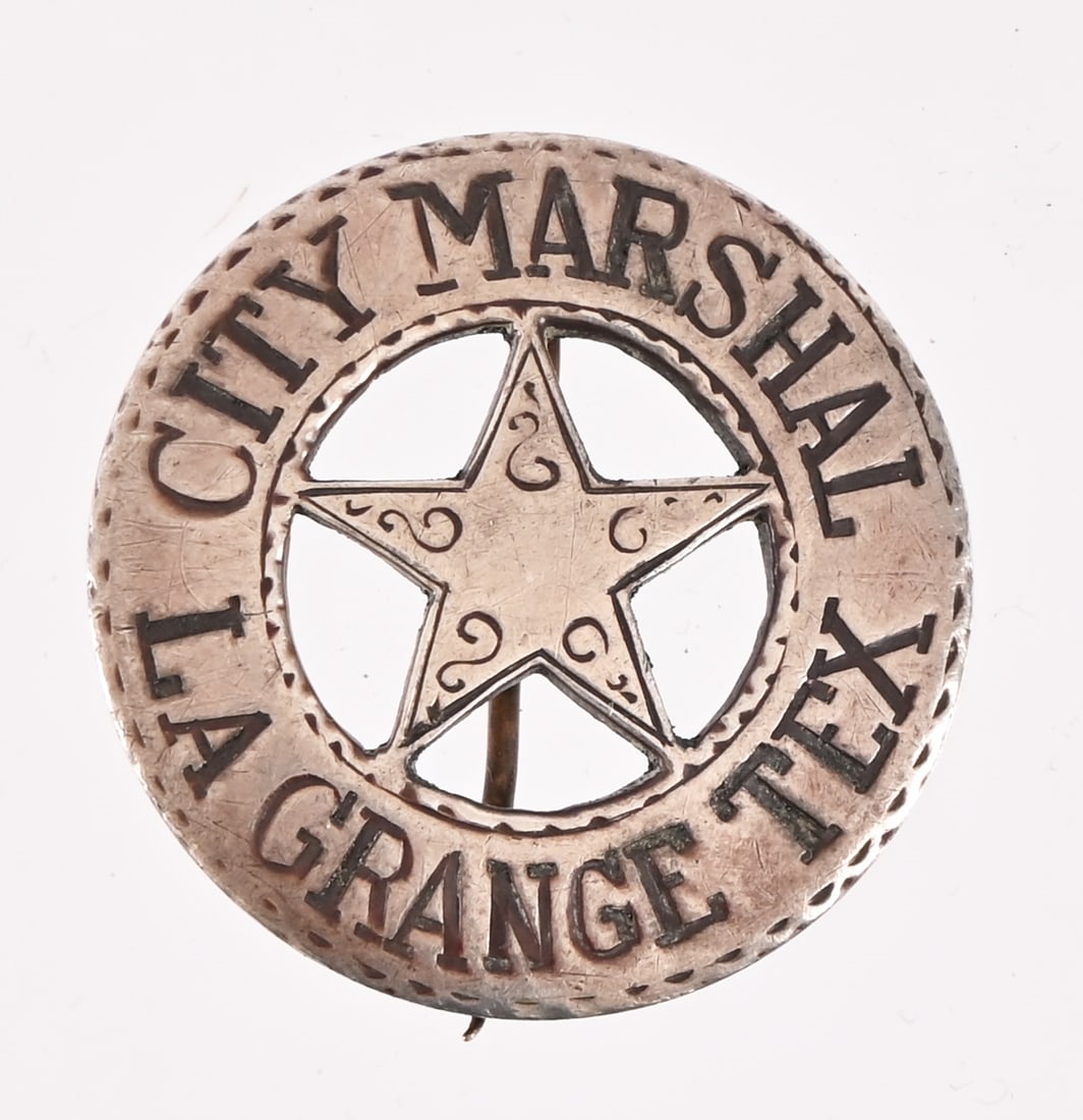 La Grange Texas City Marshal Badge: Will Loessin's Jeweler made badge from an 1875 American silver fifty cent coin with "Will Loessin" inscribed on the back of the badge. Loessin served as La Grange City Marshal from 1900-1920. He was e