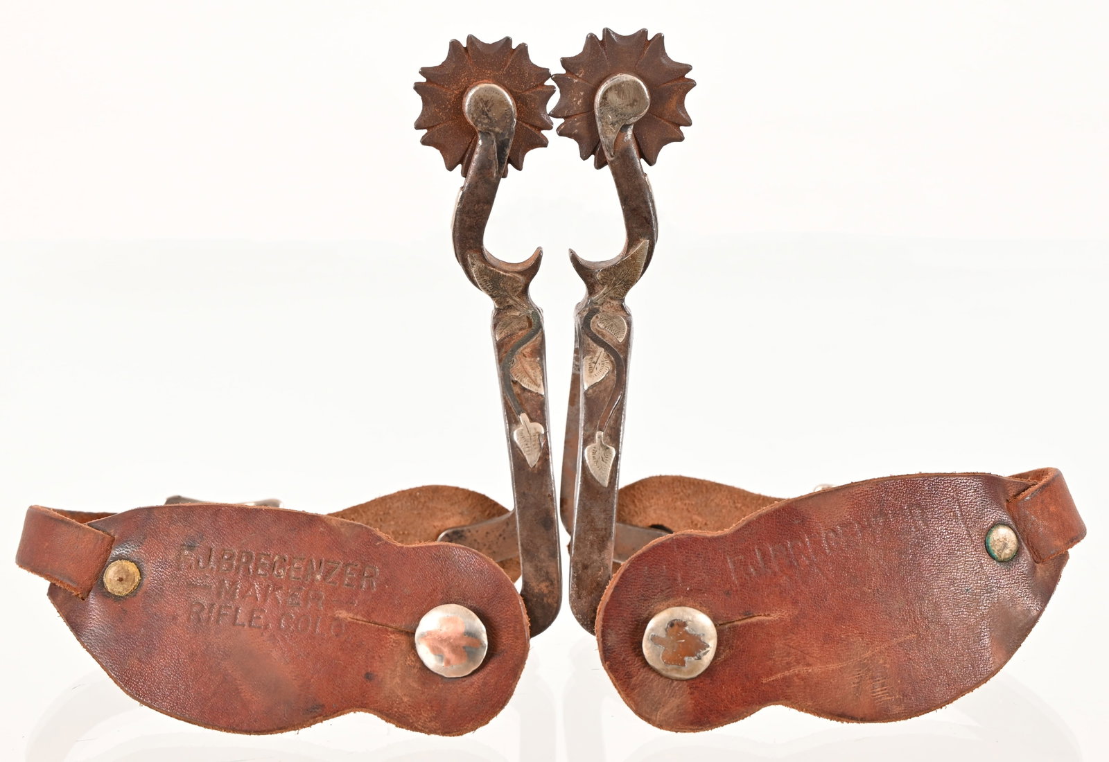 J.R. McChesney Silver Mounted Bottle-Opener Spurs: No.7 Pattern Bottle-opener shank spurs. Silver floral overlay