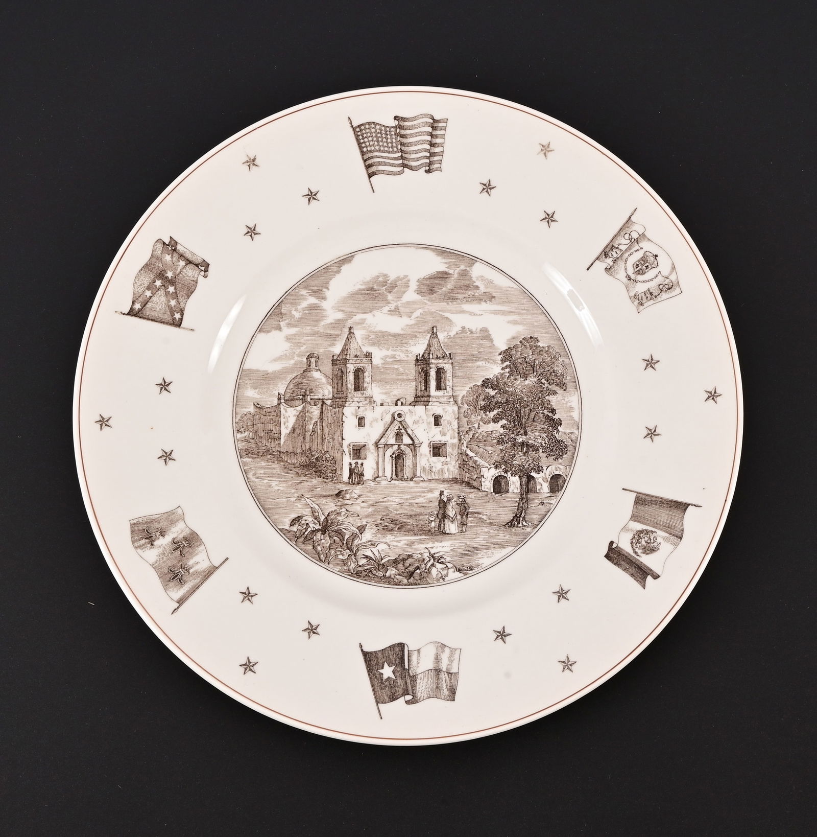 Mission Concepcion Commemorative Plate: Designed by Josiah Wedgwood and Sons Ltxd. Neiman Marcus. Border shows the flags of the six sovereign powers in Texas History. Measures 10 1/2" diameter.