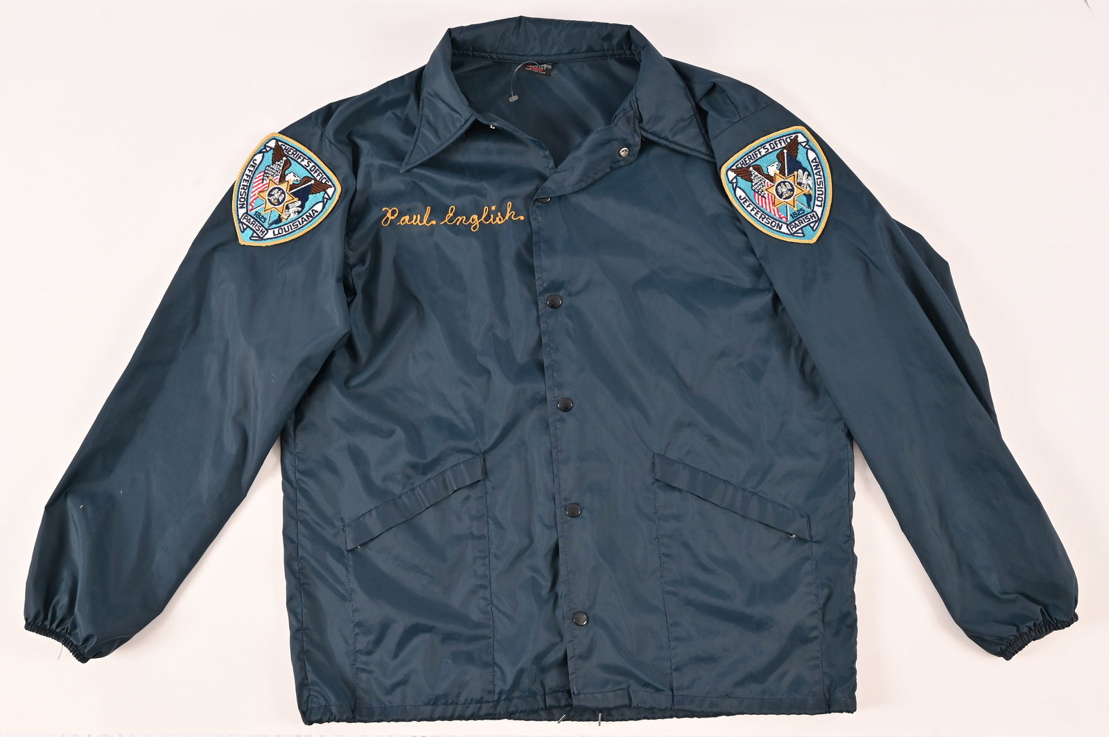 Paul English Jefferson County Parish LA Rain Coat: Embroidered "Paul English" on front with Jefferson County Parish Sheriff's Office patch on both sleeves. Brand: Aristo Jack Hilton. Size: Large.