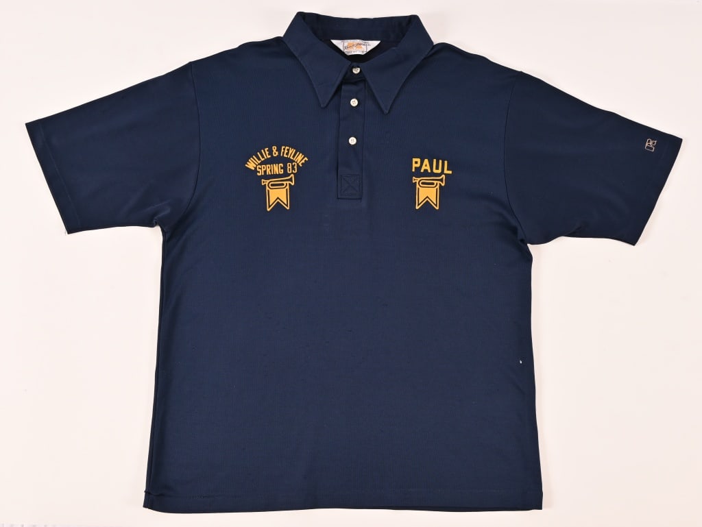 Willie & Feyline 1983 Paul English's Tour Shirt: Feyline was starting in 1967 by Barry Fey. Barry Fey and Willie Nelson collaborated on several projects, primarily in the world of music and film including Red Headed Stranger. Fey co-owned the Mauie