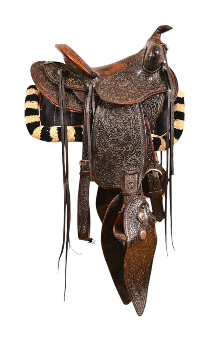 Edward H. Bohlin Tooled Saddle, Bit & Bridle: Edward H. Bohlin carved saddle, adorned with silver conchos and includes matching bit and bridle. 14" Seat