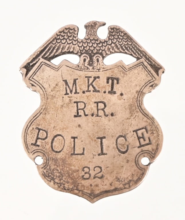 Missouri-Kansas-Texas Railroad Police Badge: Early railroad badge. Shield with eagle, old style pin back. Etched scalloped edge.