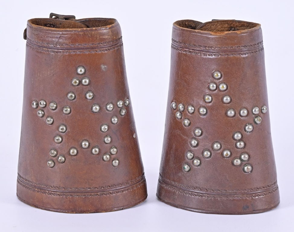 3 Pair Leather Cowboy Wrist Cuffs: Lone star nickel rivets. Border stamped, buckles intact. Desert Rose pattern. F. Muller, Denver marked. Straps and buckles intact. 3" flower designs with 33 border spots on each cuff. All nickel spots