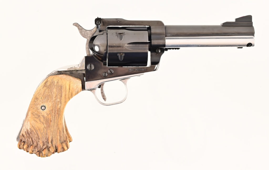 Ruger Blackhawk .41 Magnum Revolver: S/N 40-02904. Blue finish, aluminum grip and ejector housing. Staghorn grips, 4.75" barrel, decent bore. Some finish and material loss to frame and barrel, as well as finish loss to cylinder, mar on l