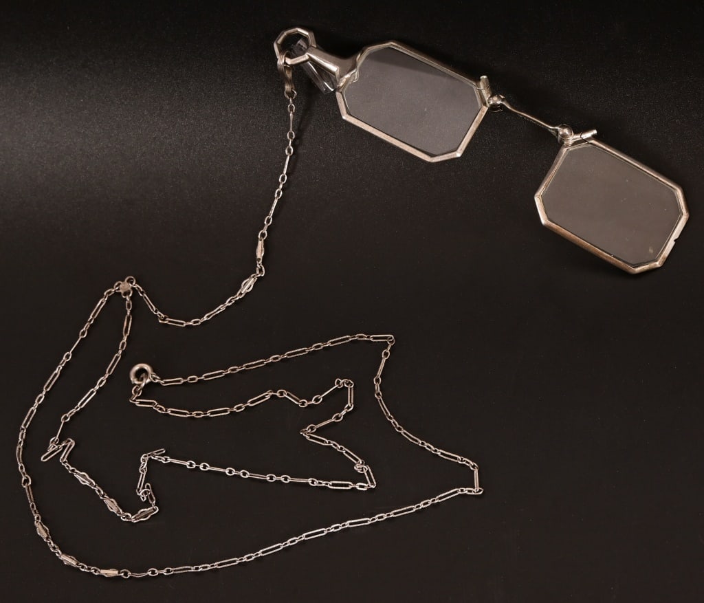 Antique Sterling Silver Folding Opera Glasses: Octagonal cut lenses in Sterling Silver marked foldable frame. Sterling 17" chain. Glasses measure 1" x 4.5"