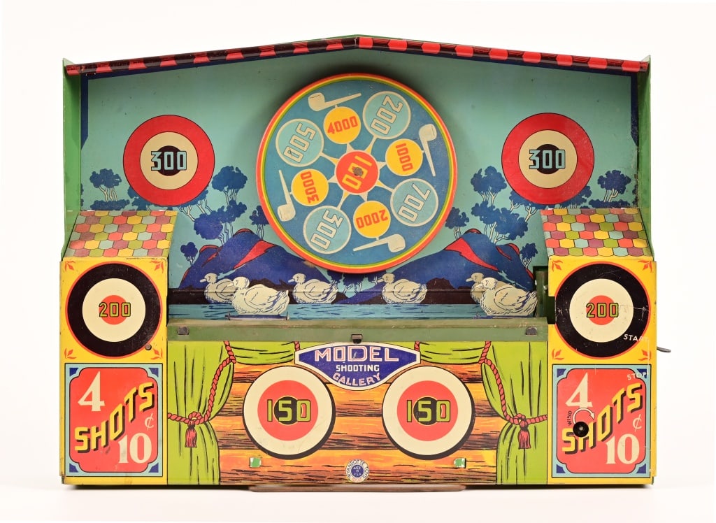 Wyandotte Pressed Tin Shooting Gallery: Tin Lithographed windup model shooting gallery. Working condition, however missing wind key and band has stretched, as normal with these toys over time. Measures 2" x 11" x 14"