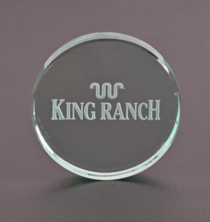 King Ranch Glass Paperweight: Embossed with King Ranch and their Running W brand, approximately 4" diameter.