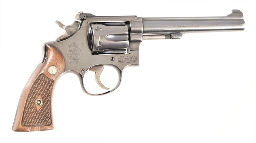 Smith & Wesson Model K22 Revolver .22LR: S/N 38588. K22 model. 6" barrel, good bore. Tight action. Good finish with only some blue loss near end of barrel. Nice S&W grips. Modern. Comes with non-matching, modern S&W box.