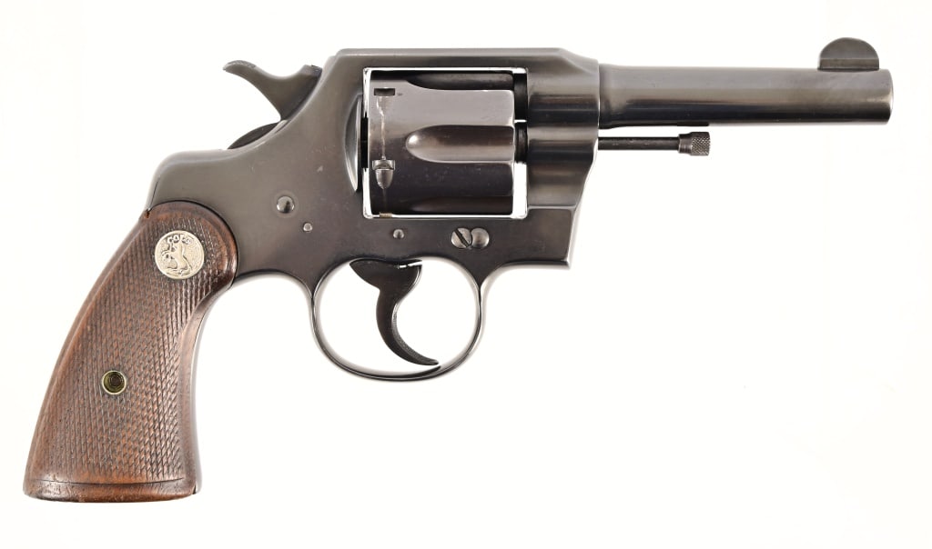 Colt Official Police Revolver .38 Spl.: S/N 571830. Very good condition. Blued finish, checkered wood grips with Rampant Colt medallion, 4" barrel. Modern