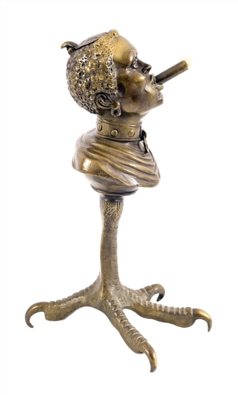 Lonesome Dove Prop Cigar Lighter: Antique cast Iron base, Clawfoot brass top with lighter & cutter in head. Measures 7" x 17" Used in the filming of the original Lonesome Dove. From the collection of the late Moody Anderson. Moody