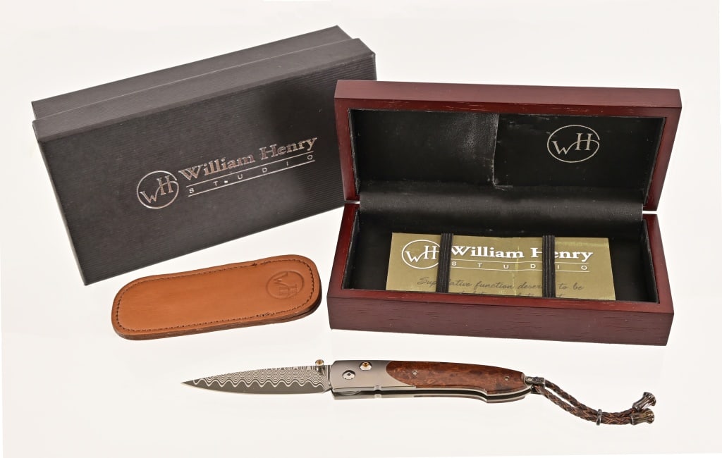 William Henry Studio Custom Damascus Lancet Knife: Model B10-TIW, circa 2009. Wave pattern Damascus blade; Aerospace grade titanium frame; 18k gold bezels set with citrine gemstones. Stabilized Desert ironwood scales