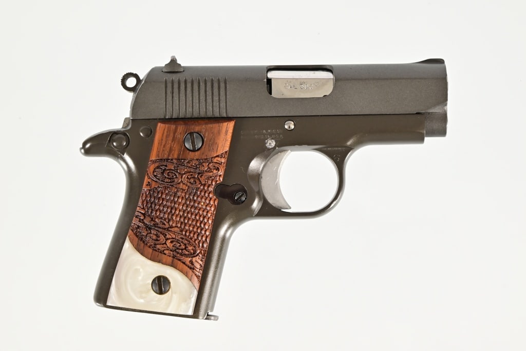 Colt Mustang Pocket Lite .380 Semi Auto Pistol: 1 5/8" barrel. Wood and pearl grips. Good action, some finish loss on left side of slide. Modern.