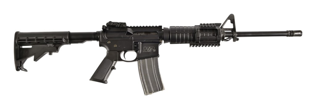 Smith & Wesson MP15 5.56 NATO Semi Auto Rifle: S/N ST71141. Magpul flip up rear sight, Safariland for end rail kit, and 5 extra magazines. 18" barrel. Modern.