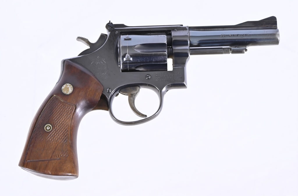 Smith & Wesson Mod. 48 .22 Magnum Revolver: SN K420258. 4" barrel, fair bore. Well used but action is tight. Grips have been altered. Modern.