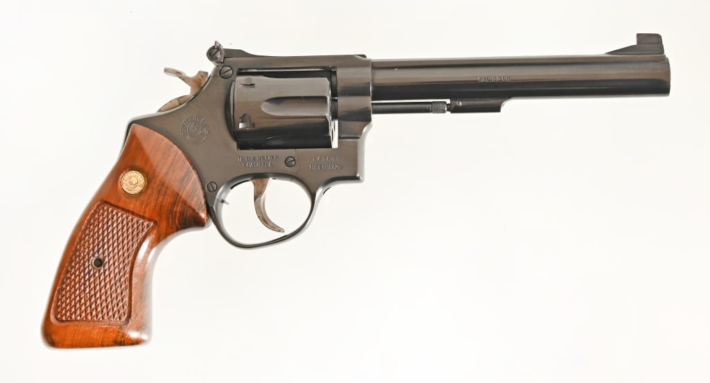 Taurus .22 LR Revolver: 6" barrel, blue finish, wood checkered grips. Made in Brazil, imported by Taurus INT. MFG., Miami, FLA. SN: 145699. Modern.