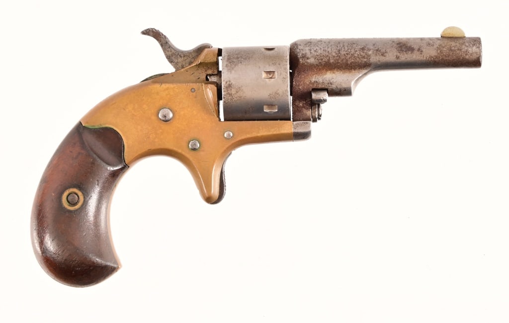 Colt Open Top .22 Pocket Revolver: S/N 69376, Manufactured in 1875. Brass frame, walnut grips, 2 3/8" barrel. Action works, cylinder revolves, rough brown bore. Mottled pitting in finish. Antique.