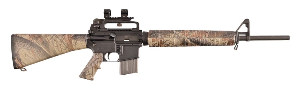 Bushmaster XM15-E2S Semi-Auto 5.56 Rifle: S/N BFI440530. Camo scheme, 20" barrel 5.56 Nato 1/9 twist H Bar. Modern.
