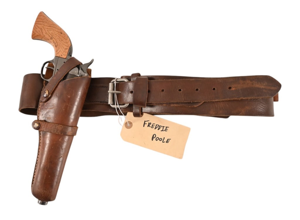 Yellowstone 1923 Freddie Poole Holster Prop Rig: Leather RH draw holster rig with metal prop single action revolver. Belt marked 45 on leather near buckle, and back to back "R's" brand on inside of belt. Freddie Poole was a stunt man in the popular