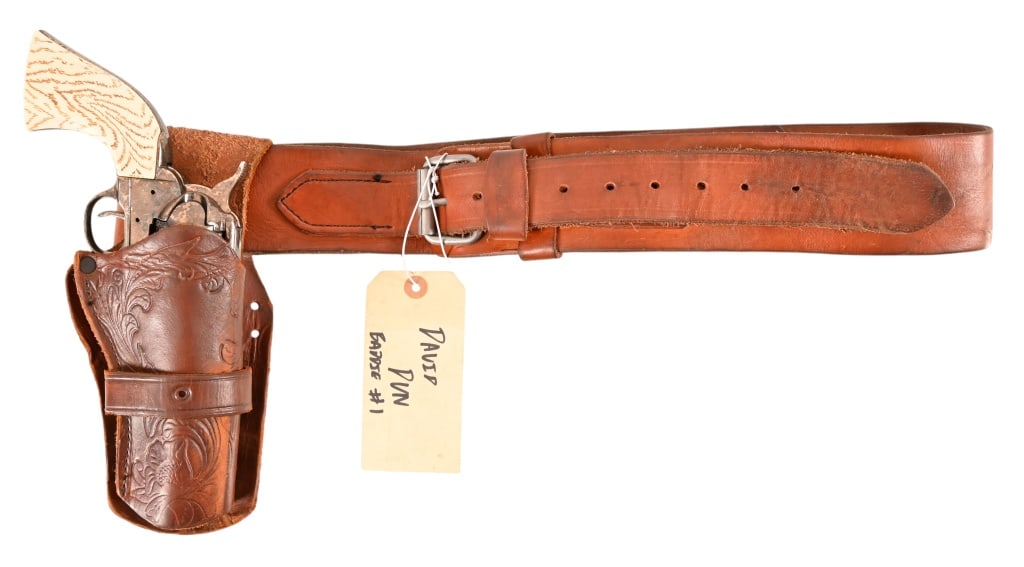 Yellowstone 1883 Gun Belt And Holster Prop Rig: From the popular TV series 1883 A Yellowstone Origin Story. Leather gun belt and holster rig with metal single action prop pistol. Has 2 - 1883 brands and back to back "R's" brand on inside of belt.