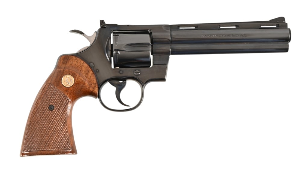 Colt Python .357 Magnum Revolver: 6" barrel, blue finish, wooden textured grips, like new condition. SN: E69991.