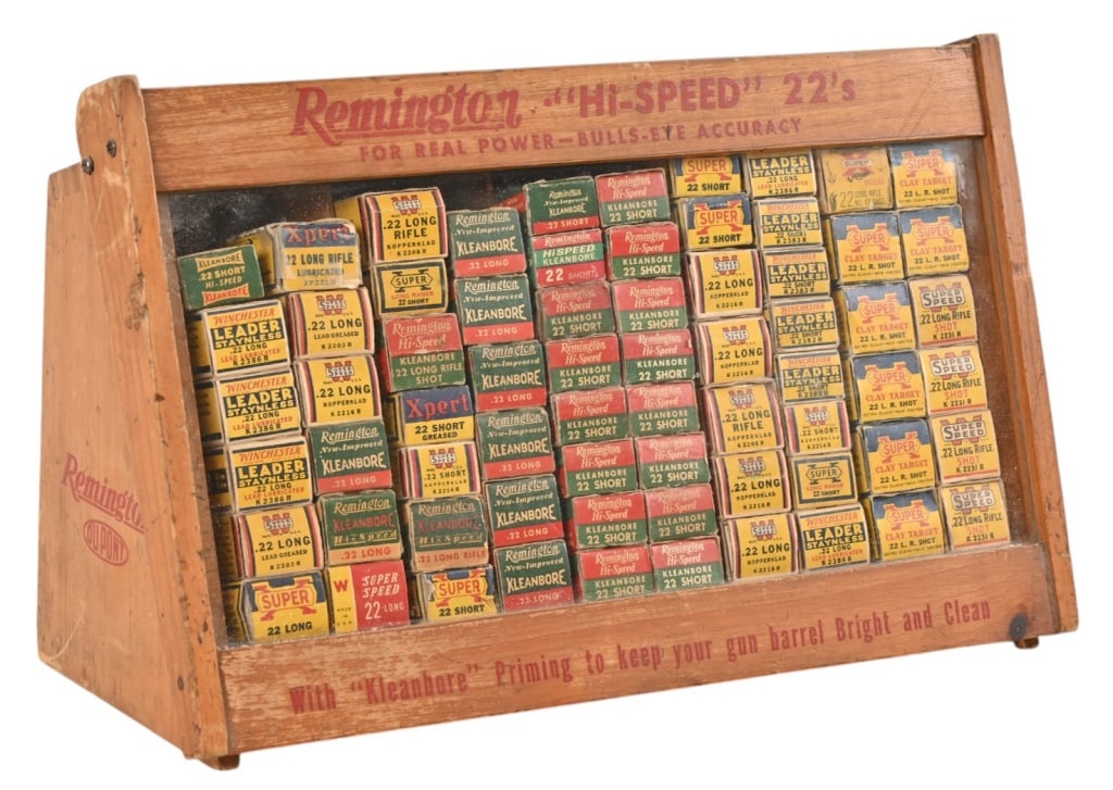 Remington "Hi-Speed" .22 Countertop Display Case: Glass slant front door swings upward, 68 boxes. Some boxes are empty, and most have empty .22 brass casings. No live rounds. Case measures 16" wide x 6 1/2" deep (base) x 9 3/4" tall. NOTE: Local pick
