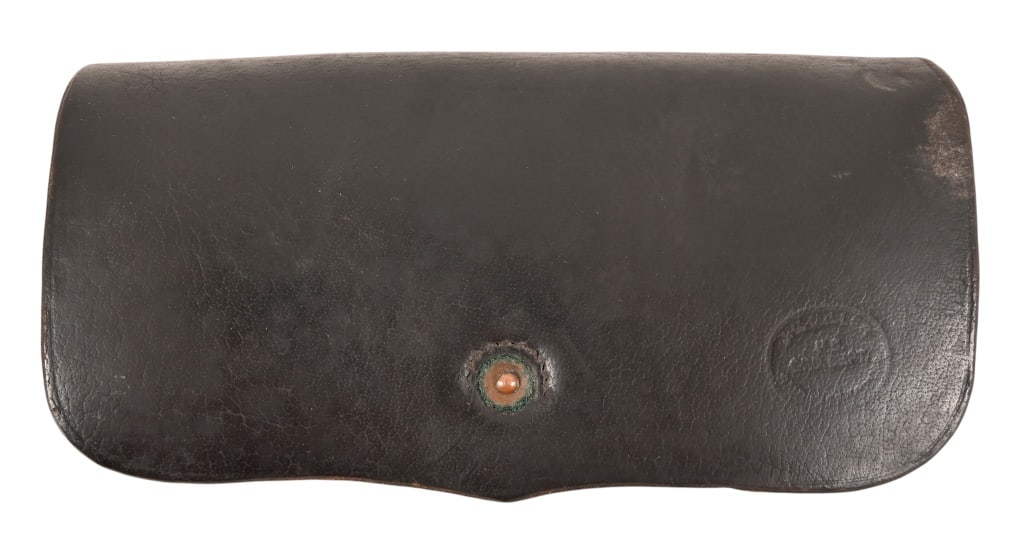 J.C. Miller Leather Cartridge Pouch: Dark leather pouch, stamped J.C. Miller U.S. Ord Dept. Cover under outer flap stamped E. Gaylord with some unreadable text under the name. Holds 20 rounds. Measures approximately 8 1/2" x 3" x 4 3/4".