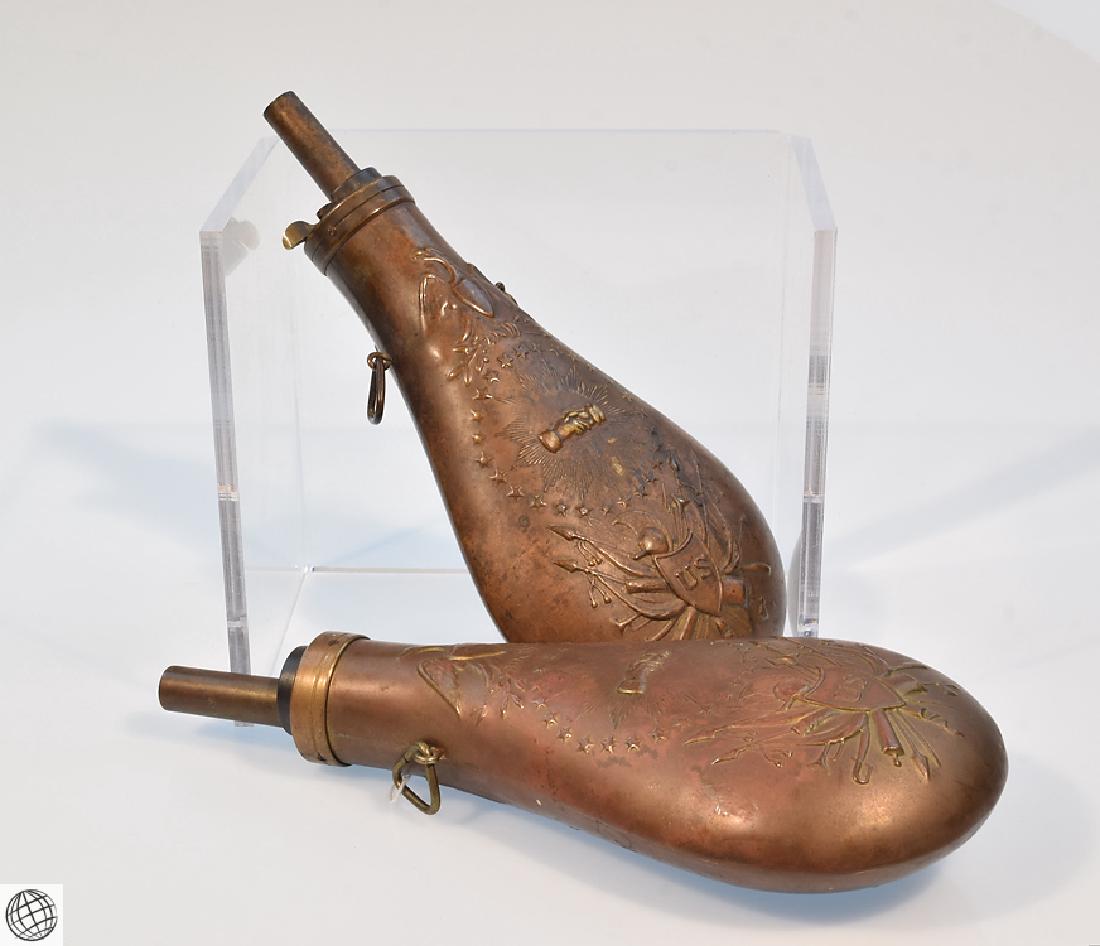 2Pcs. Civil War EAGLE PEACE BLACK POWDER FLASKS 19th: Details: This lot consists of 2 Peace Eagle Black Powder Flasks from our Civil War Estate Collection. One of these is authentic and the other a known reproduction, having been tagged as such by the c