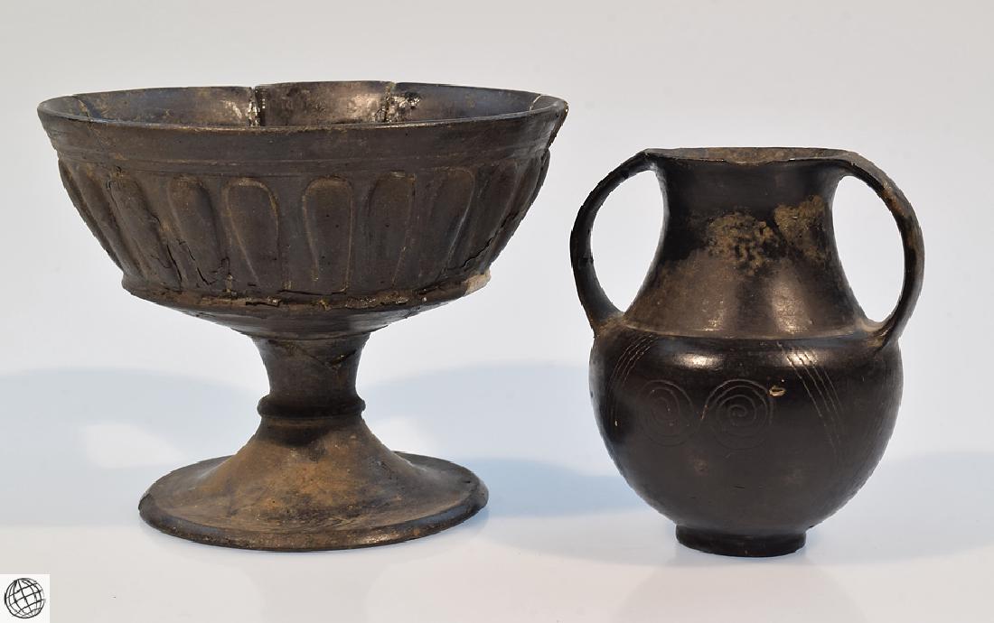 2Pcs Bucchero Chalice Kylix Vase ETRUSCAN POTTERY Black: Details: This 2Pcs lot of Etruscan pottery includes a bucchero chalice or kylix on black ware or burnished ware with fluted sculptural design and a small bucchero vase dating to approximately 800BCE w