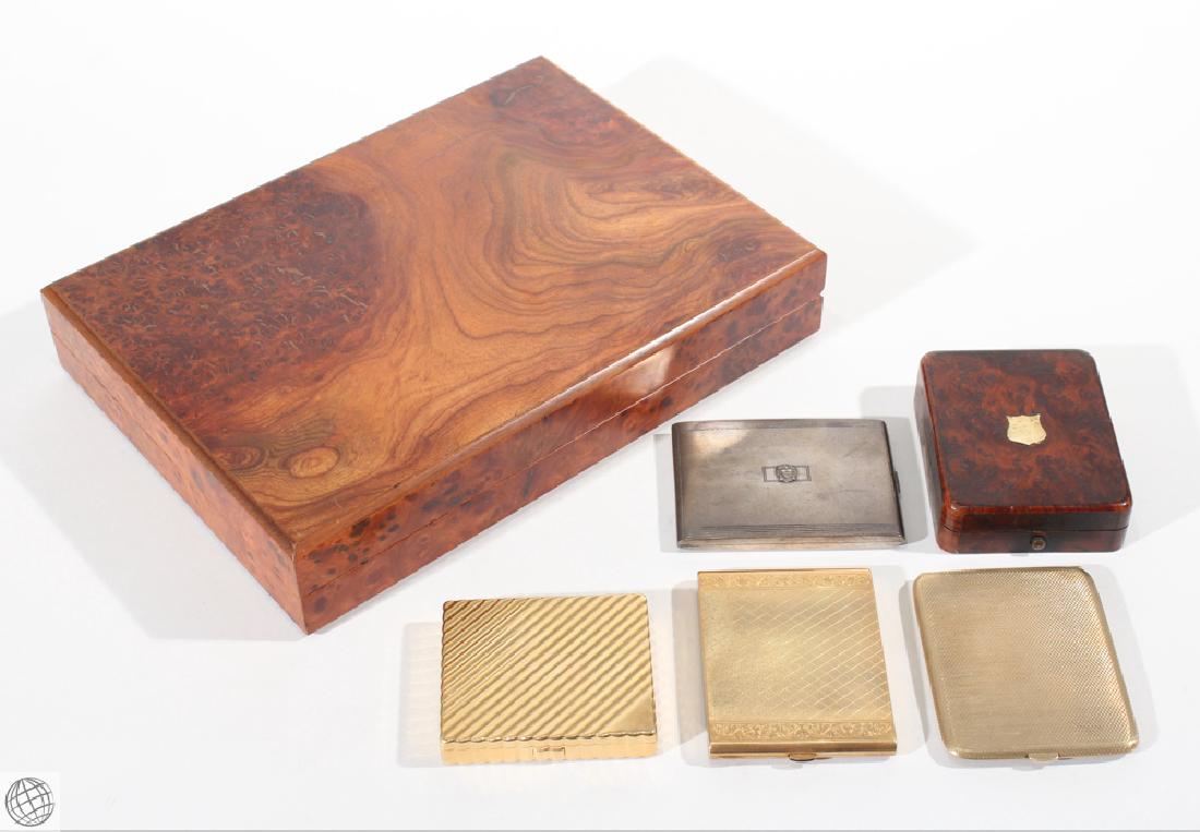 6Pcs Decorative VINTAGE CIGARETTE AND CIGAR CASES Burl: Details: 6Pcs. This lot comprises a collection of Decorative Vintage Cigarette Cases and a Portable Burl Humidor. No. 1: Decorative burl surfaced humidor box measuring 12 1/4" in length by 9" wide by 