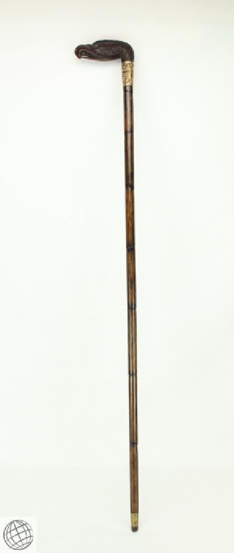 Antique ORNATE CARVED EAGLE HANDLE WALKING CANE c 1900s: Details: Antique decoratively carved and gilded eagle head walking cane. Measures 35 1/2" in length. A carved eagle head forms the handle, with an ornate gilded gold collar below the handle. Dark colo
