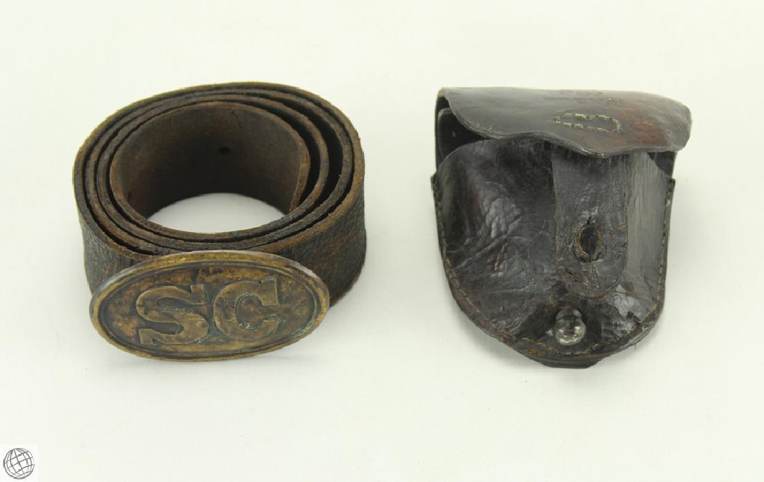 2Pcs Confederate Accouterments SC BELT BUCKLE PLATE: Details: 2Pcs This lot consists of an antique Civil War South Carolina belt buckle plate found on a leather belt as well as a leather percussion cap box. This lot is from the estate of a well-known an