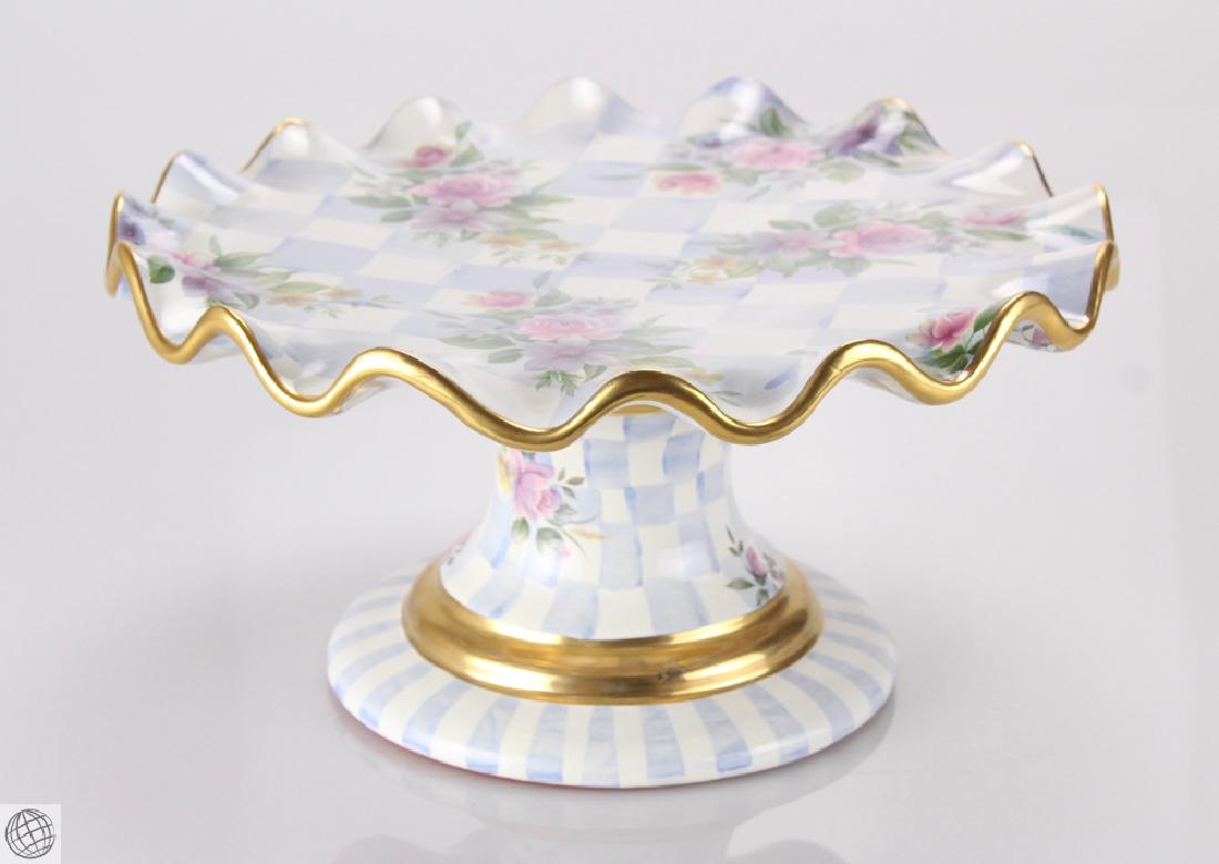 Retired Blue Honeymoon MACKENZIE CHILDS Fluted Pedestal: Details: This lot consists of a Mackenzie Childs Pedastal Cake Plate in the retired blue Honeymoon floral pattern. This pale blue checked and floral cake stand with a fluted rim edged in gold was hand