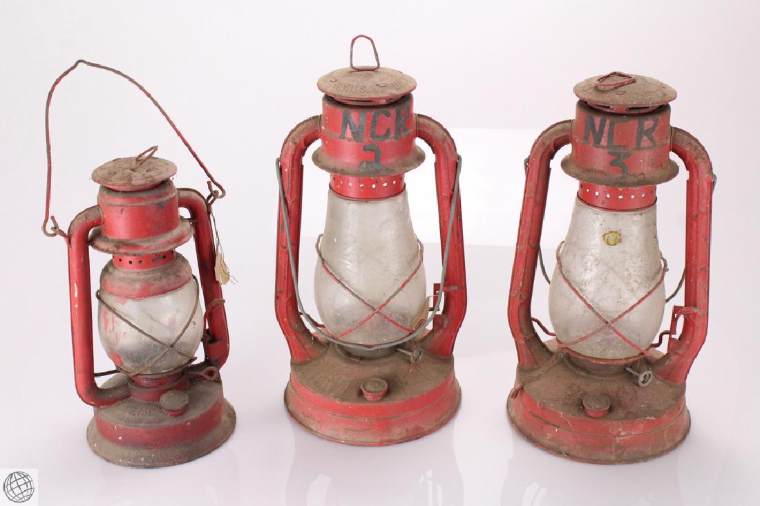 3Pcs Historical Memorabilia ANTIQUE RED OIL LANTERNS: Details: This lot comprises three antique fireman's lanterns. Consisting of two Dietz Blizzard #2 oil lanterns. Intact glass globes, red color. Untested. Overall dimensions 8" dimater by 14" tall eac