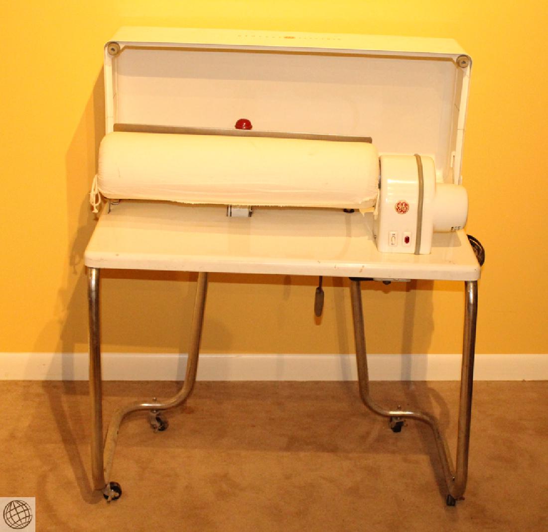 C1950s Vintage GENERAL ELECTRIC ROTARY IRONER Model: Details: C1950s Vintage General Electric Model AR51 Rotary Ironer. This is a motor assisted rotary iron for pressing sheets, fabrics, etc. Temperature selector is labeled, Silk, Rayon, Wool, Cotton,